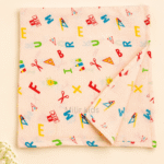100% cotton baby muslin towel with colourful alphabet and school-themed print in 70 × 70 cm size.
