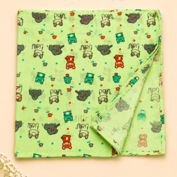 Baby muslin towel with cute animal print in green.