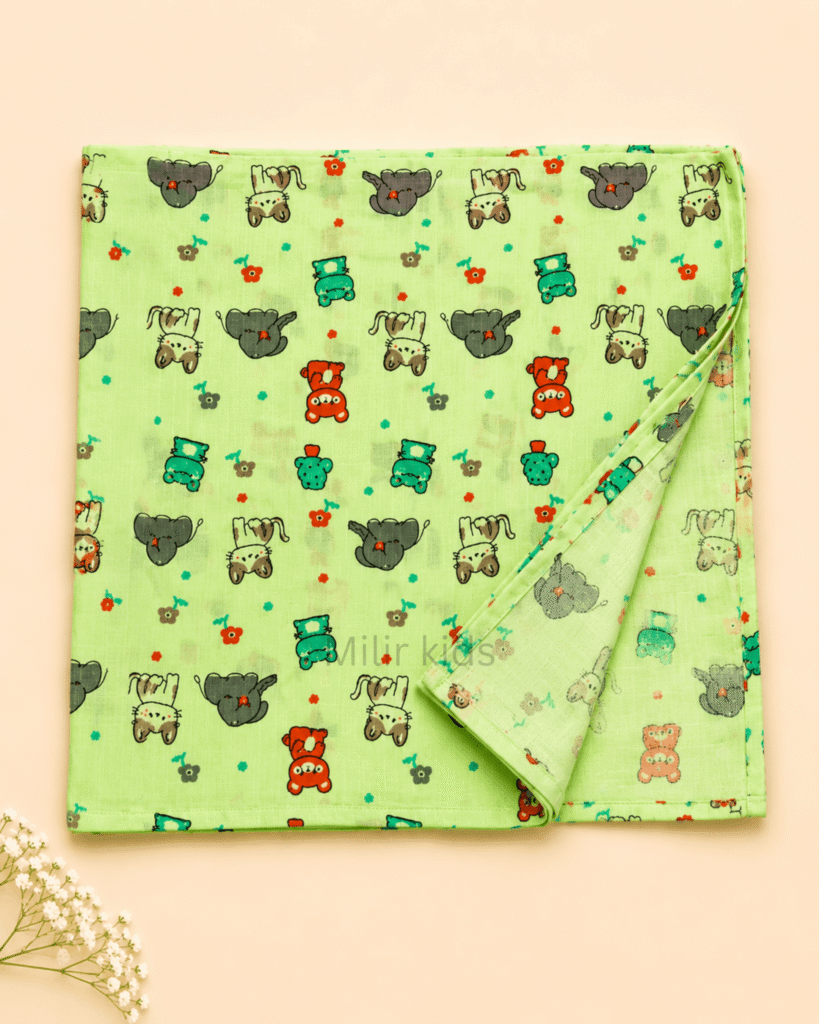 Baby muslin towel with cute animal print in green.