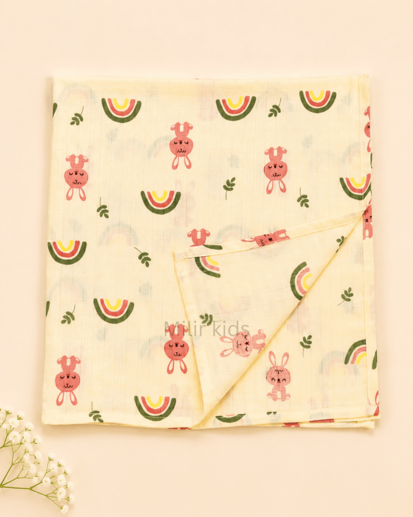 Baby muslin towel featuring cute bunny and rainbow prints.