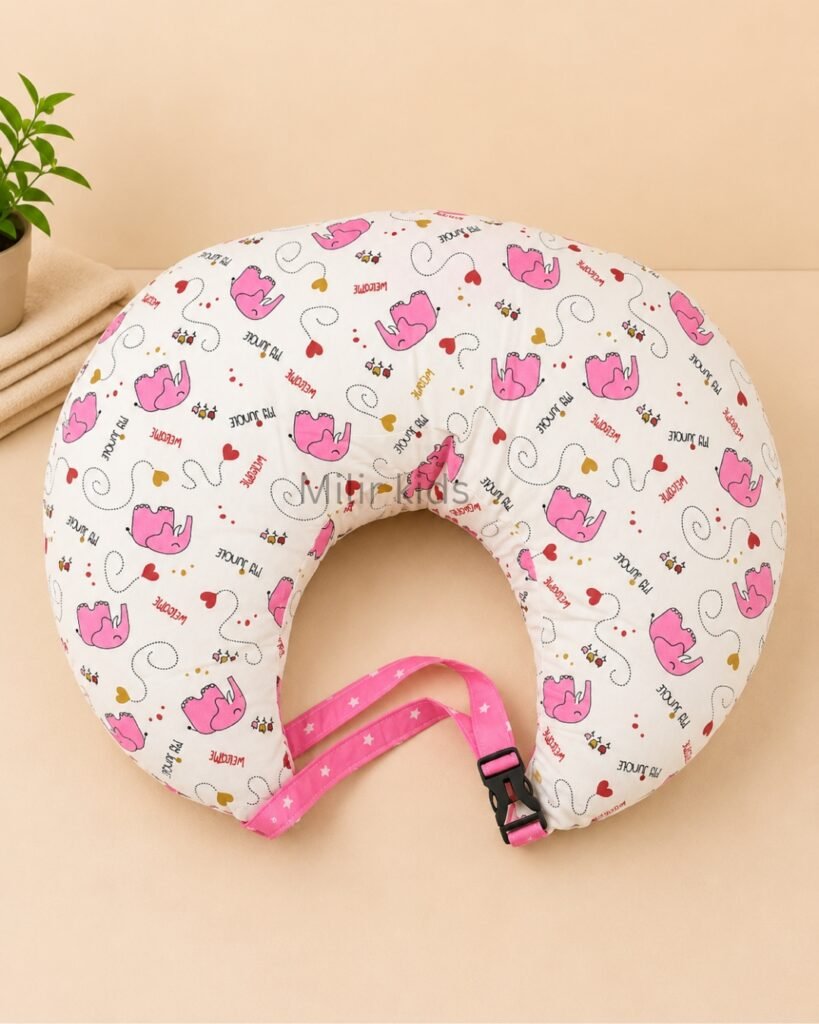 Pink baby feeding pillow with safety strap for breastfeeding and bottle feeding by Milir Kids