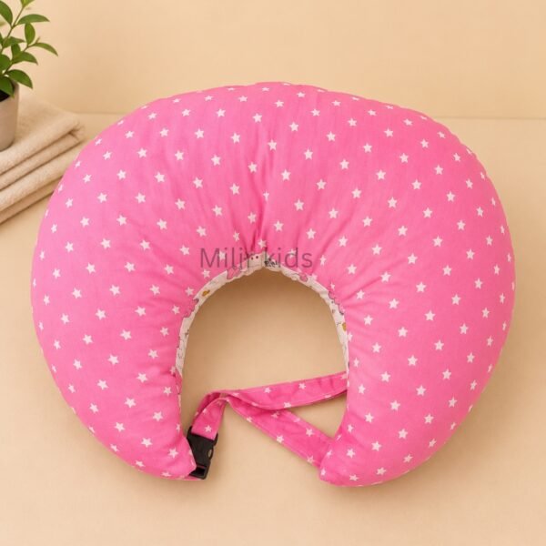 Pink baby feeding pillow with safety strap for breastfeeding and bottle feeding by Milir Kids