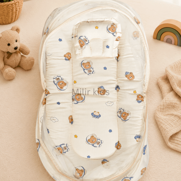 Premium muslin baby bed with mosquito net for newborn babies, soft breathable sleeping nest with head support cushion and portable design.