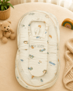 Premium muslin baby bed with mosquito net for newborn babies, soft breathable sleeping nest with head support cushion and portable design.