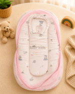 Premium muslin baby bed with mosquito net for newborn babies, soft breathable sleeping nest with head support cushion and portable design.
