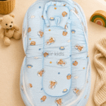 Premium muslin baby bed with mosquito net for newborn babies, soft breathable sleeping nest with head support cushion and portable design.